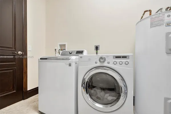 a spacious bathroom with a granite countertop double vanity sink and a mirror