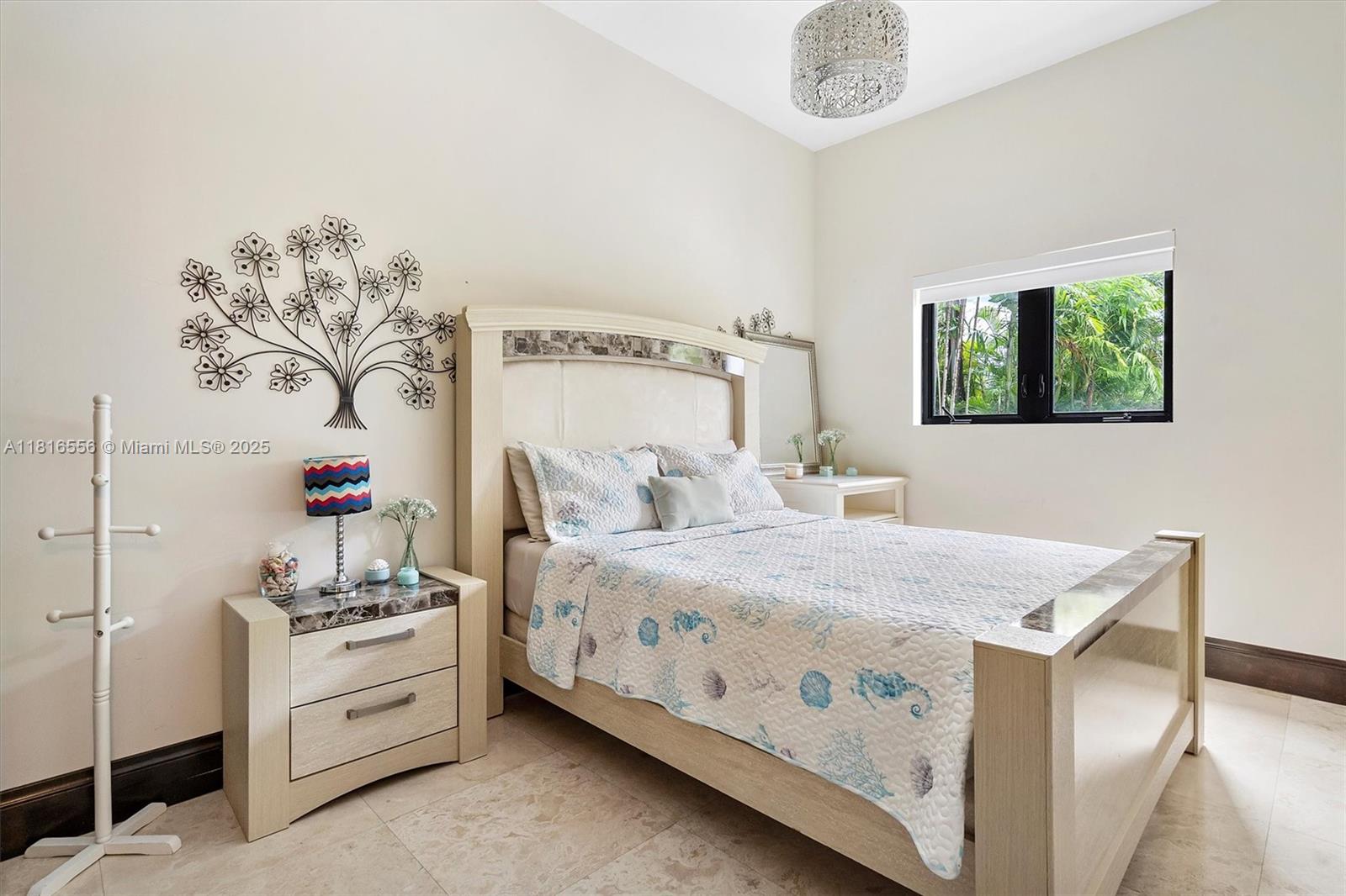 18825 North Bay Road Sunny Isles Beach, FL 33160 - Photo 34 of 62 a bedroom with a bed and a chandelier