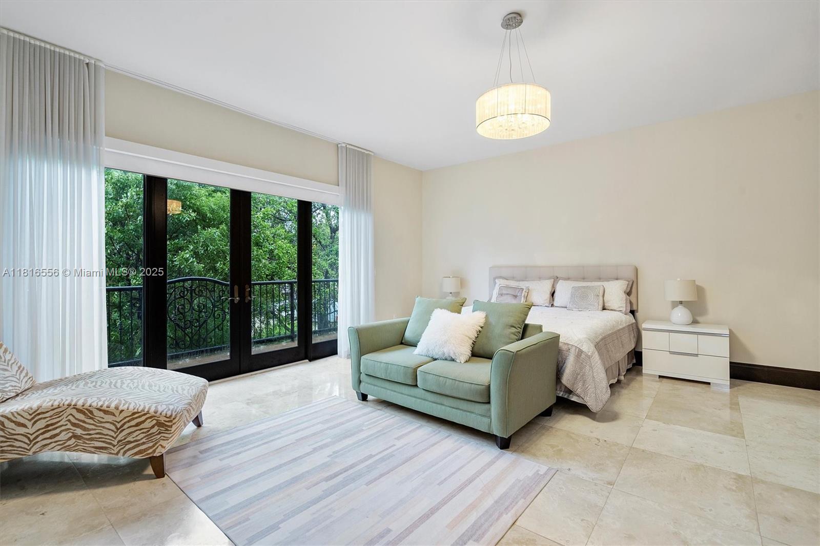 18825 North Bay Road Sunny Isles Beach, FL 33160 - Photo 38 of 62 a spacious bedroom with a bed and a large window