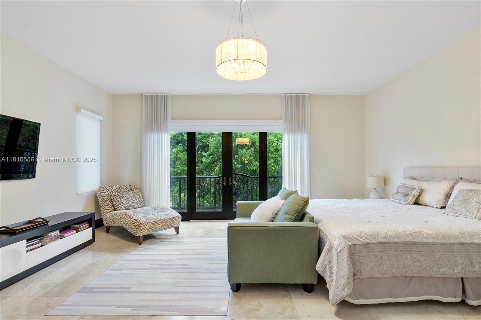 18825 North Bay Road Sunny Isles Beach, FL 33160 - Photo 39 of 62 a bedroom with a bed and a chandelier