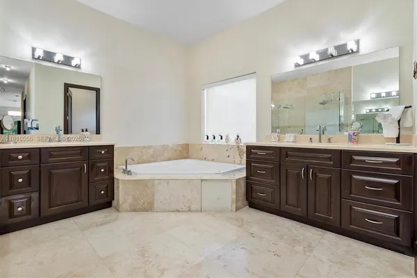 a bathroom with a sink toilet vanity and shower