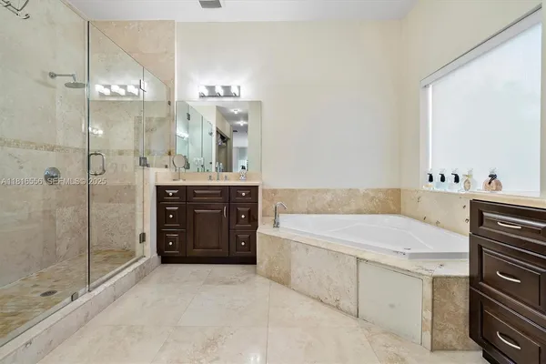 a bathroom with a double vanity sink a toilet and a mirror