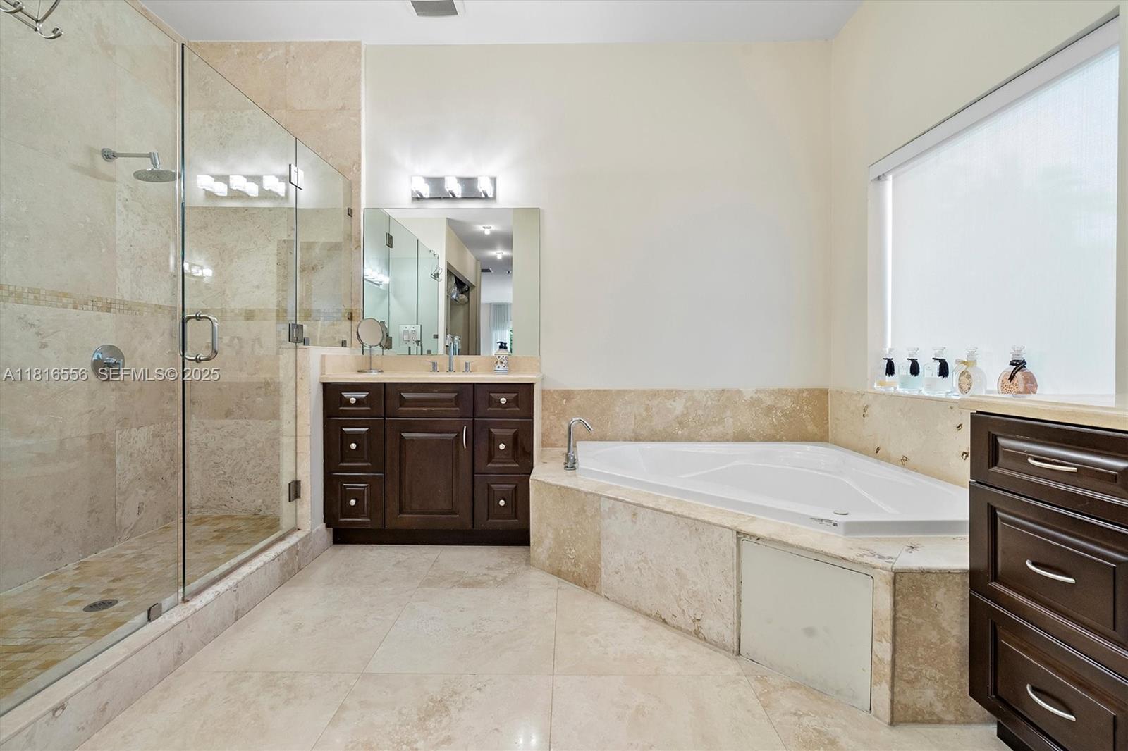 18825 North Bay Road Sunny Isles Beach, FL 33160 - Photo 44 of 62 a spacious bathroom with a granite countertop sink a toilet and shower