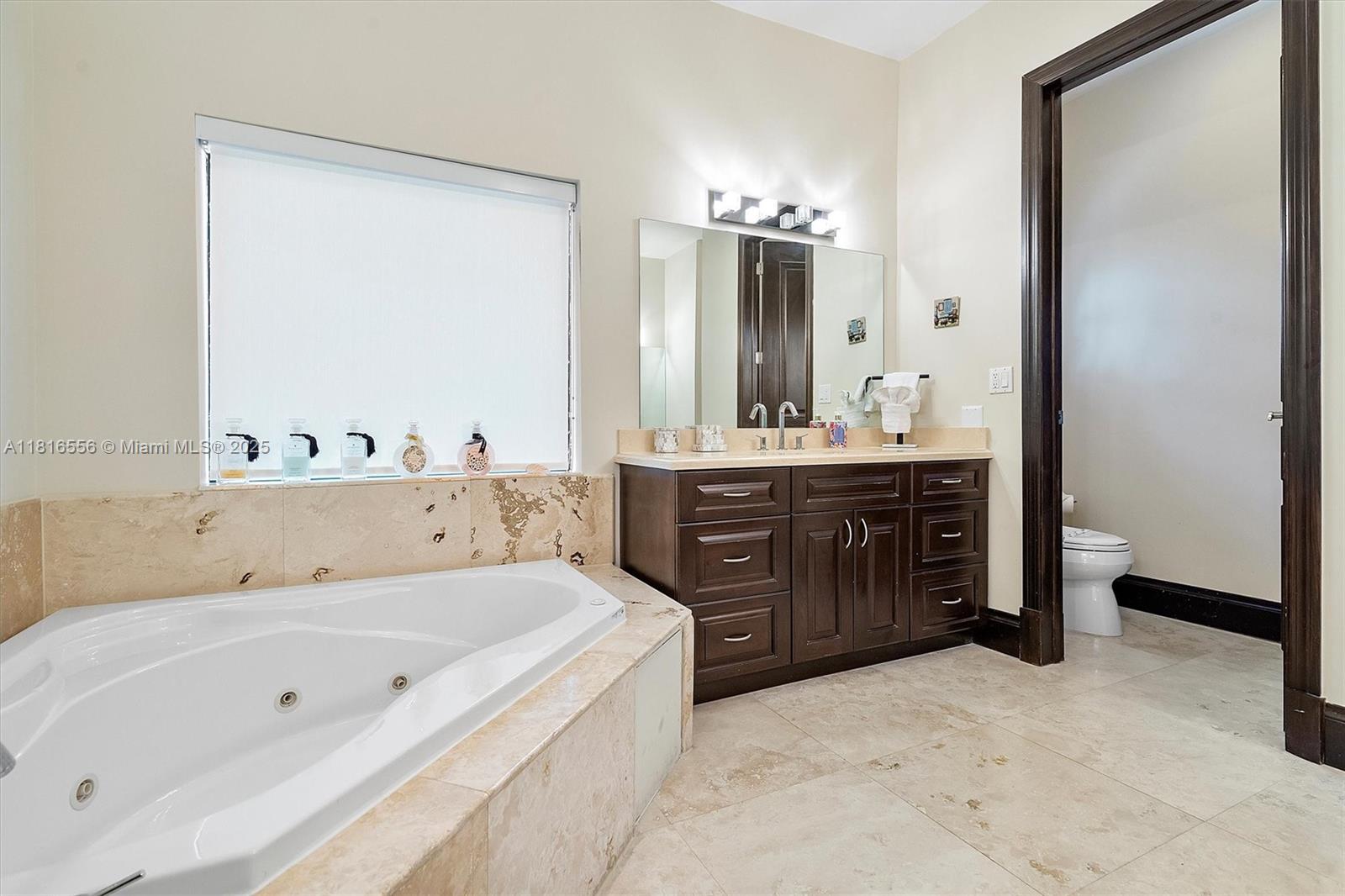 18825 North Bay Road Sunny Isles Beach, FL 33160 - Photo 46 of 62 a spacious bathroom with a tub sink and mirror