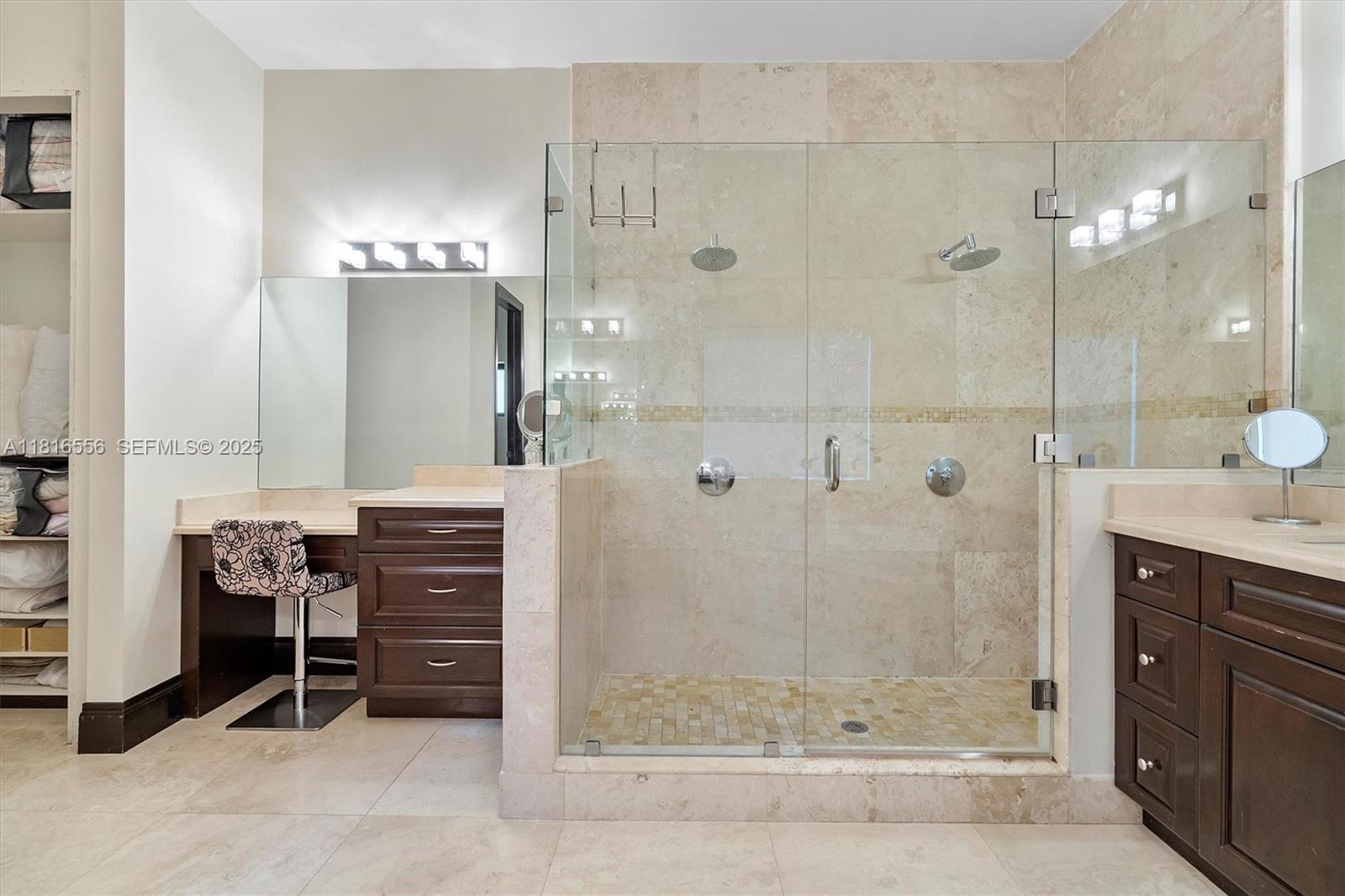 18825 North Bay Road Sunny Isles Beach, FL 33160 - Photo 48 of 62 a bathroom with a granite countertop sink a mirror and shower