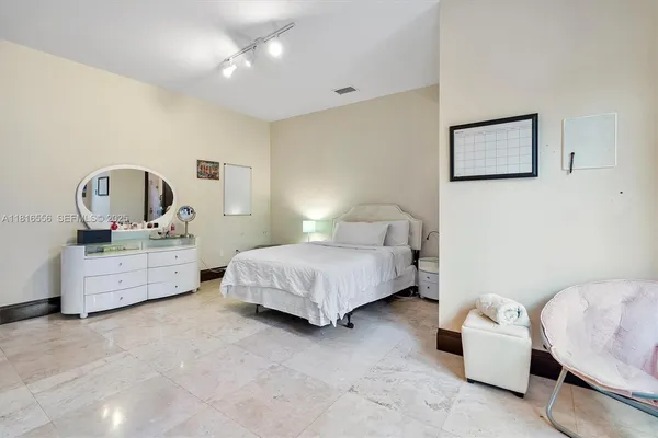 a bedroom with a bed and a tv