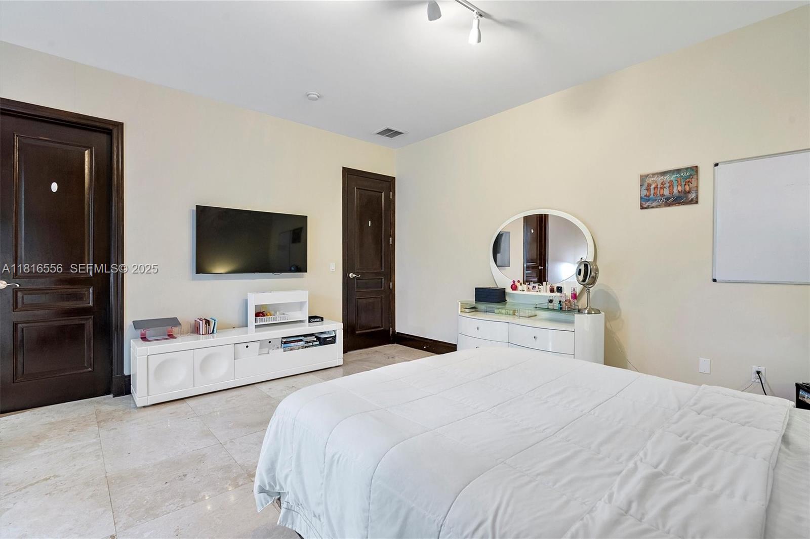 18825 North Bay Road Sunny Isles Beach, FL 33160 - Photo 52 of 62 a bedroom with a bed and a flat screen tv