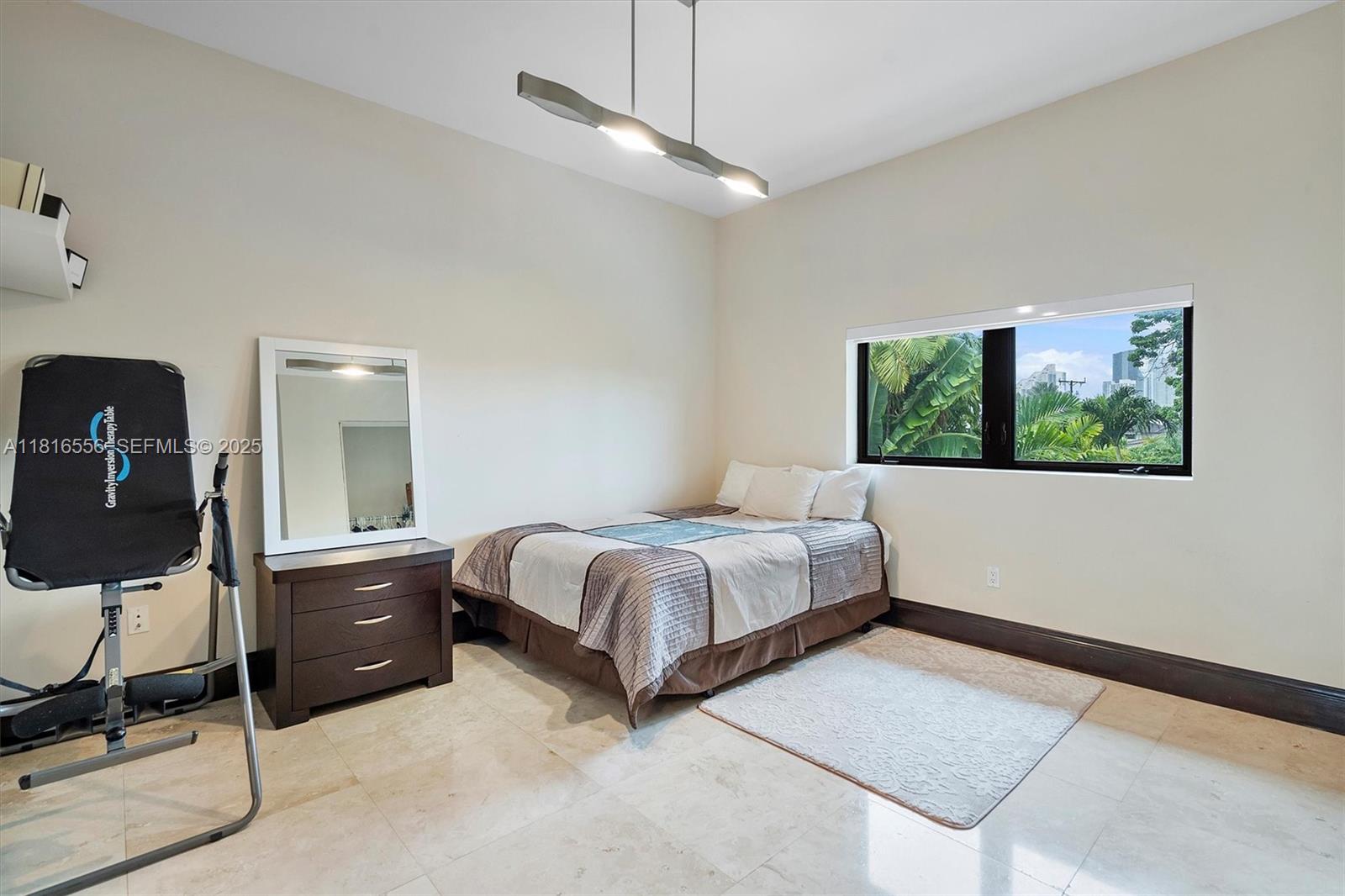 18825 North Bay Road Sunny Isles Beach, FL 33160 - Photo 54 of 62 a bedroom with a bed and a chandelier