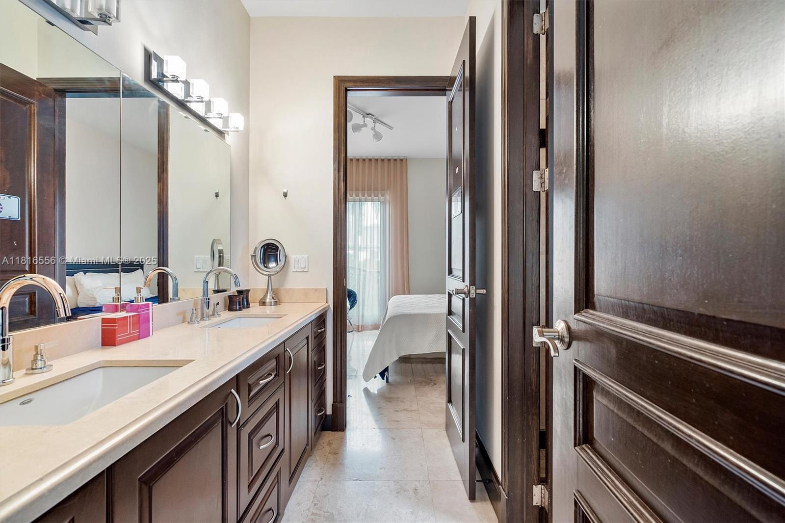 18825 North Bay Road Sunny Isles Beach, FL 33160 - Photo 55 of 62 a bathroom with a double vanity sink a toilet and a mirror