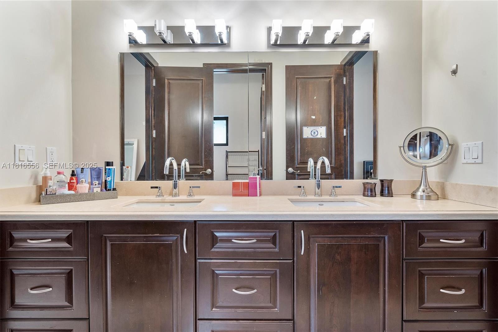 18825 North Bay Road Sunny Isles Beach, FL 33160 - Photo 57 of 62 a bathroom with a sink and a mirror