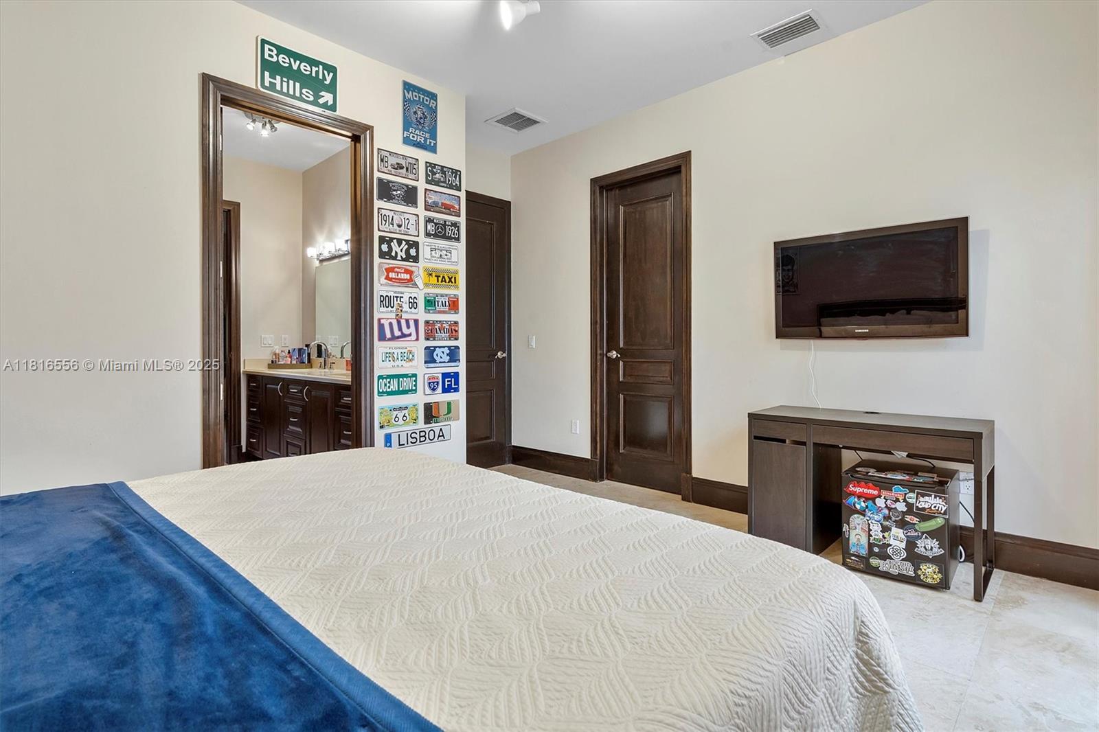 18825 North Bay Road Sunny Isles Beach, FL 33160 - Photo 61 of 62 a bedroom with a bed and a flat screen tv