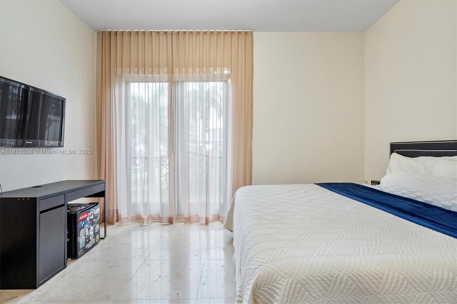 18825 North Bay Road Sunny Isles Beach, FL 33160 - Photo 62 of 62 a bedroom with a bed and a tv