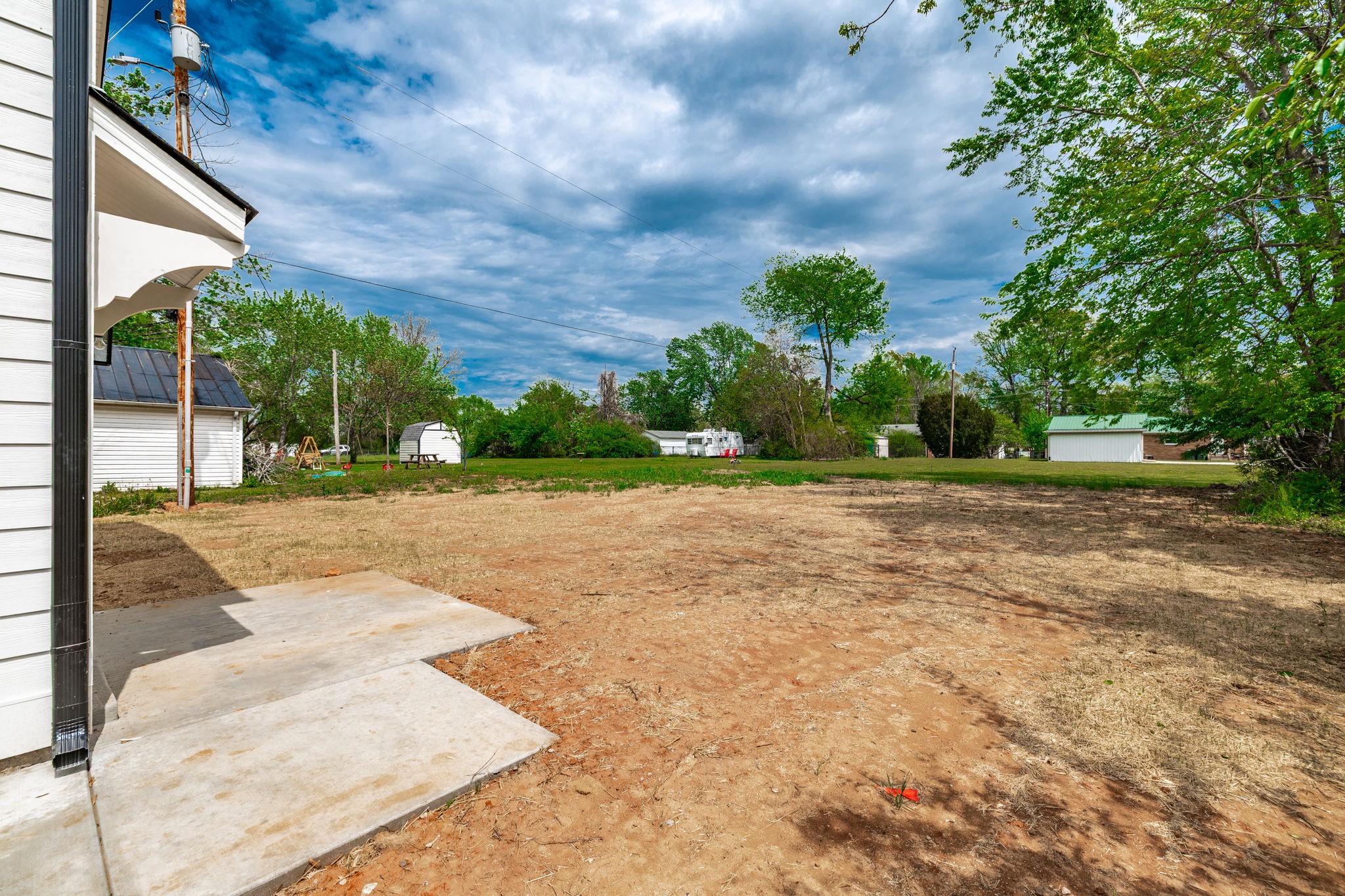 103 Portland Boulevard Portland, TN 37148 - Photo 11 of 100 a view of a yard with plants and a large tree