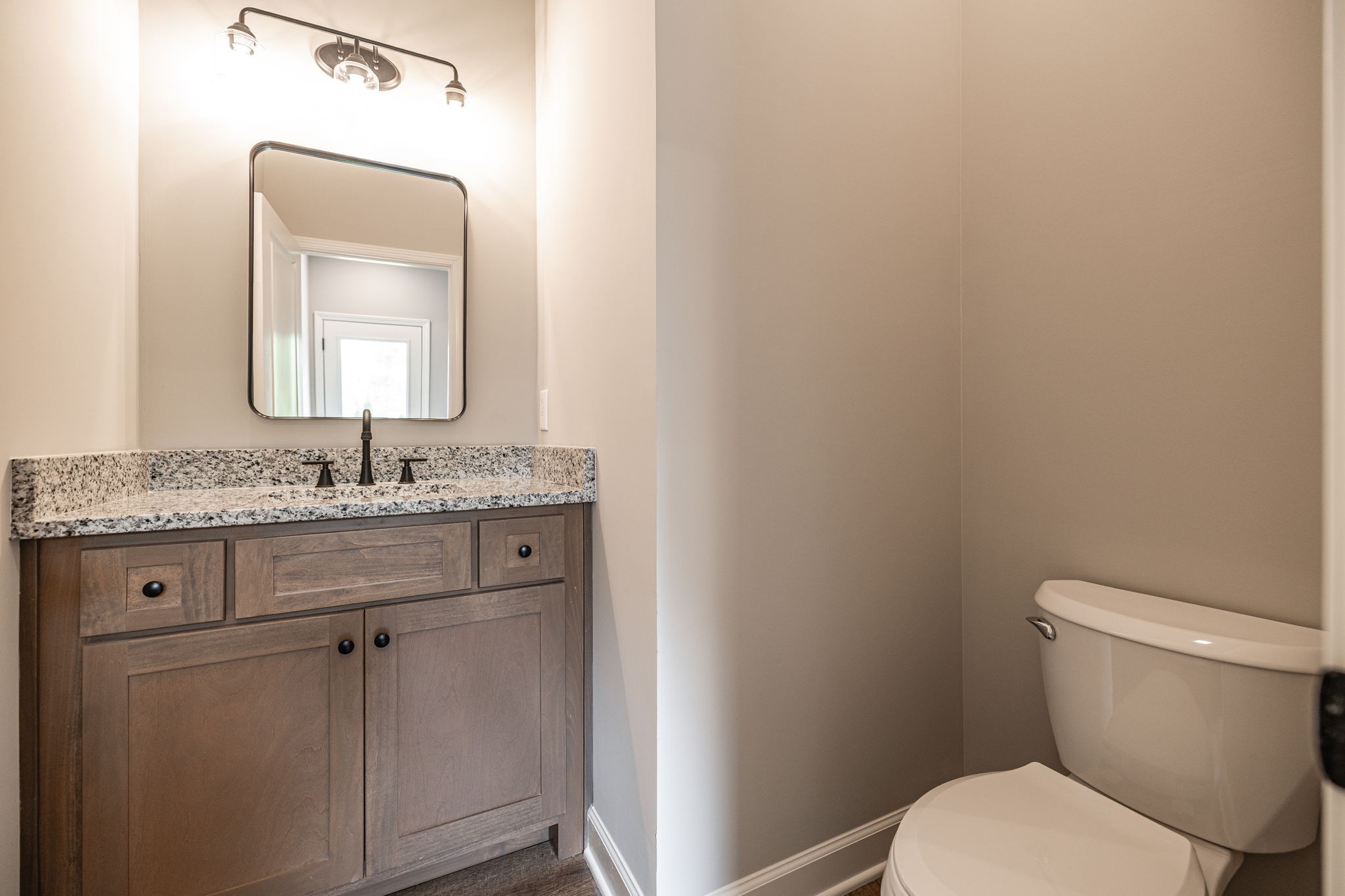 103 Portland Boulevard Portland, TN 37148 - Photo 74 of 100 a bathroom with a granite countertop toilet sink and mirror