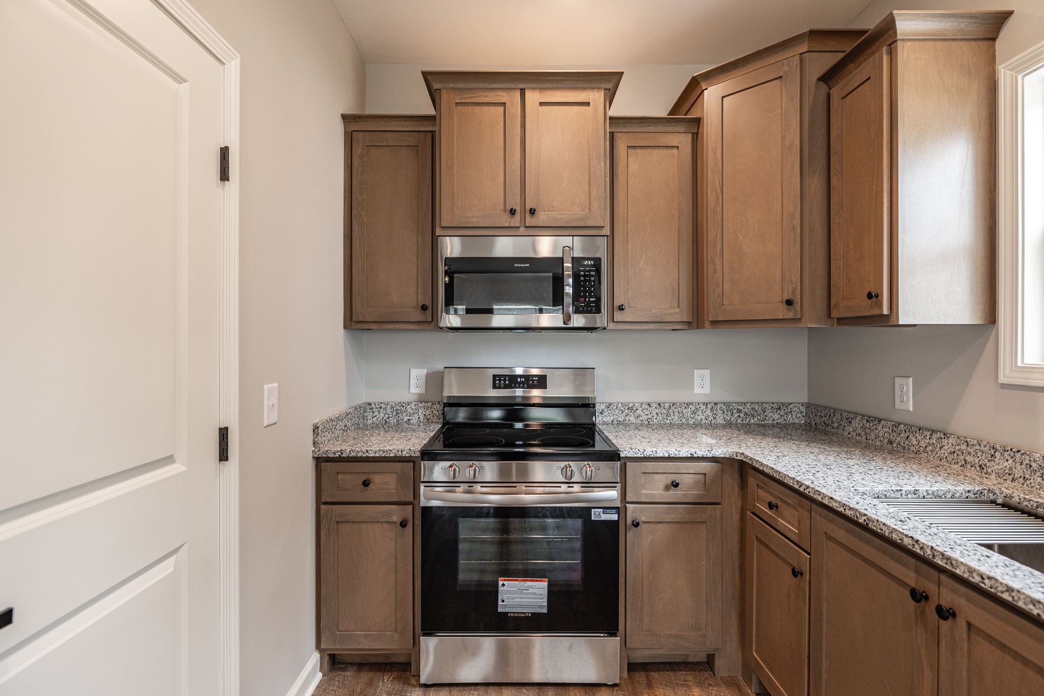 103 Portland Boulevard Portland, TN 37148 - Photo 86 of 100 a kitchen with stainless steel appliances granite countertop a stove and a microwave