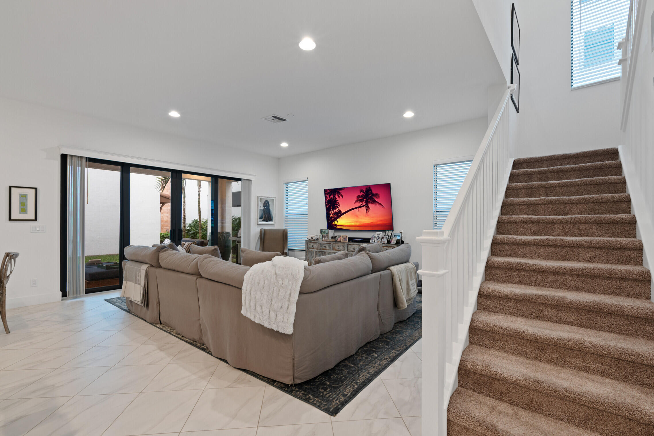 4084 Faraday Way Palm Beach Gardens, FL 33418 - Photo 12 of 43 a living room with furniture and a flat screen tv