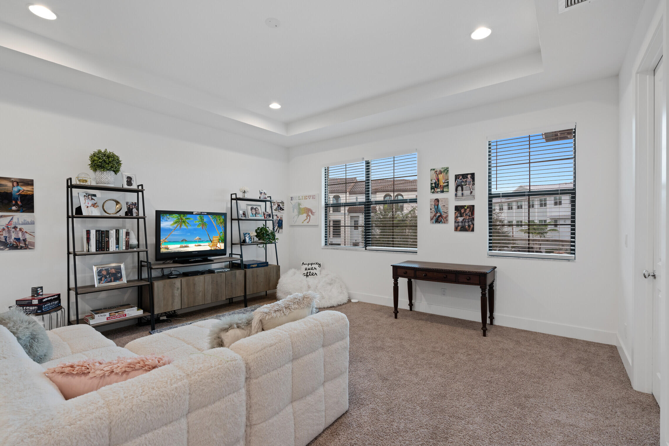 4084 Faraday Way Palm Beach Gardens, FL 33418 - Photo 20 of 43 a living room with furniture a flat screen tv and a wall painting