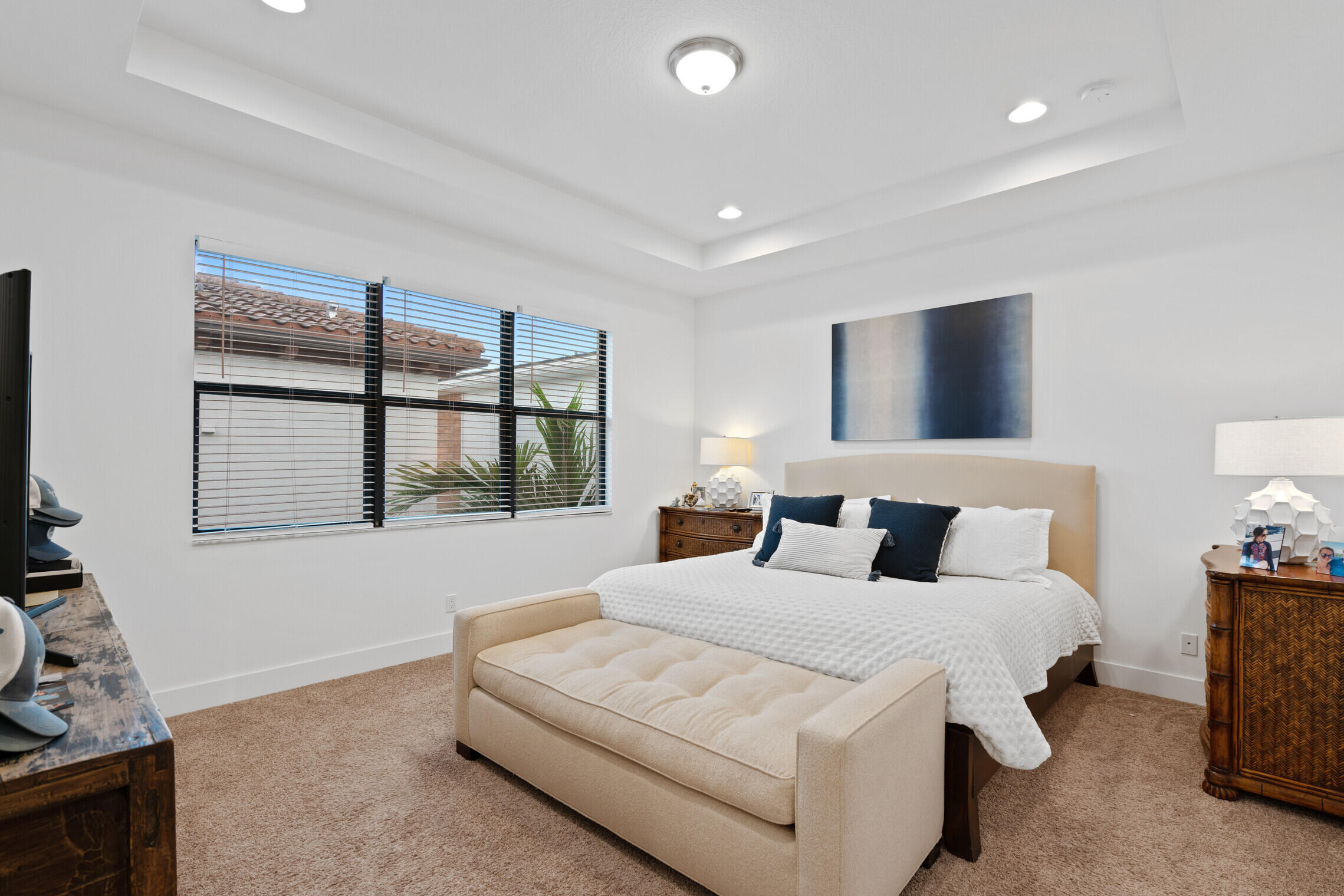 4084 Faraday Way Palm Beach Gardens, FL 33418 - Photo 21 of 43 a bedroom with a large bed and a flat tv screen on dresser