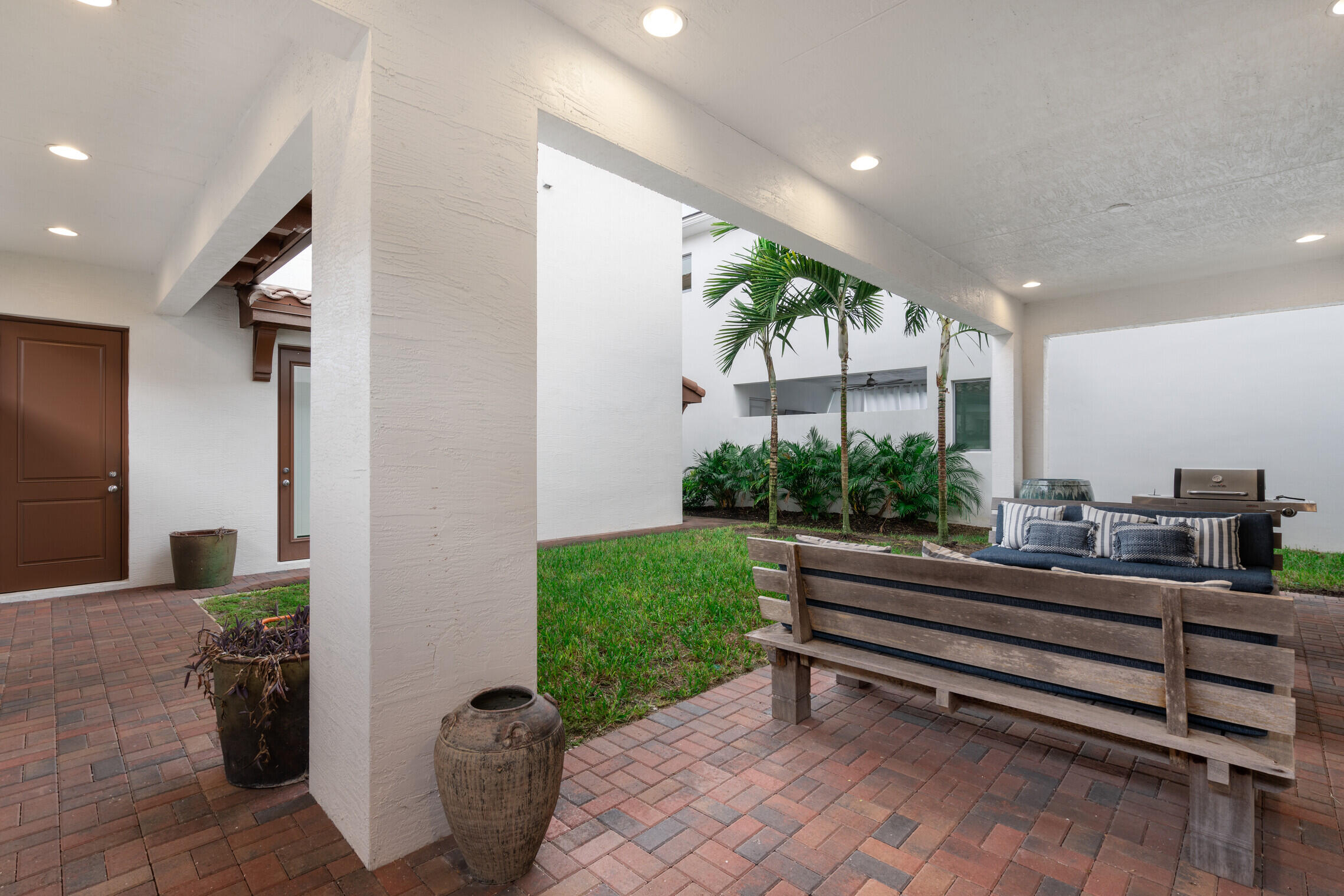 4084 Faraday Way Palm Beach Gardens, FL 33418 - Photo 29 of 43 a room with lots of potted plants wooden floor and a potted plant