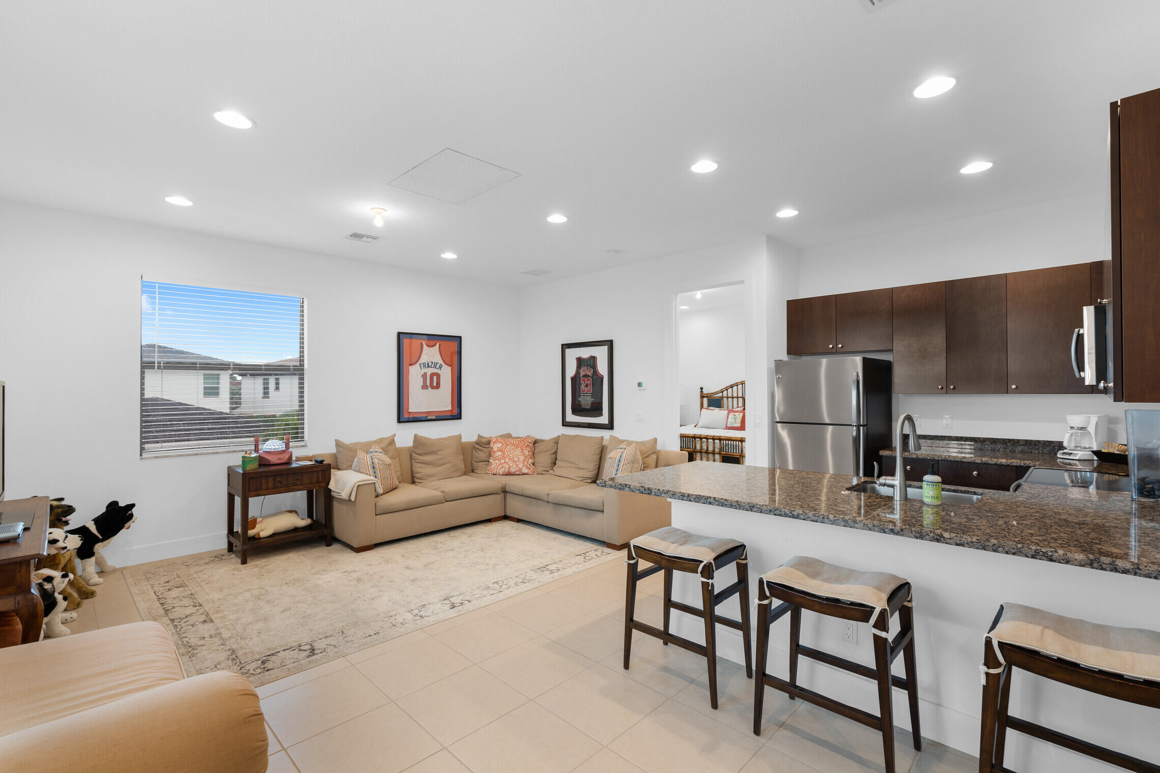4084 Faraday Way Palm Beach Gardens, FL 33418 - Photo 32 of 43 a living room with furniture and kitchen view