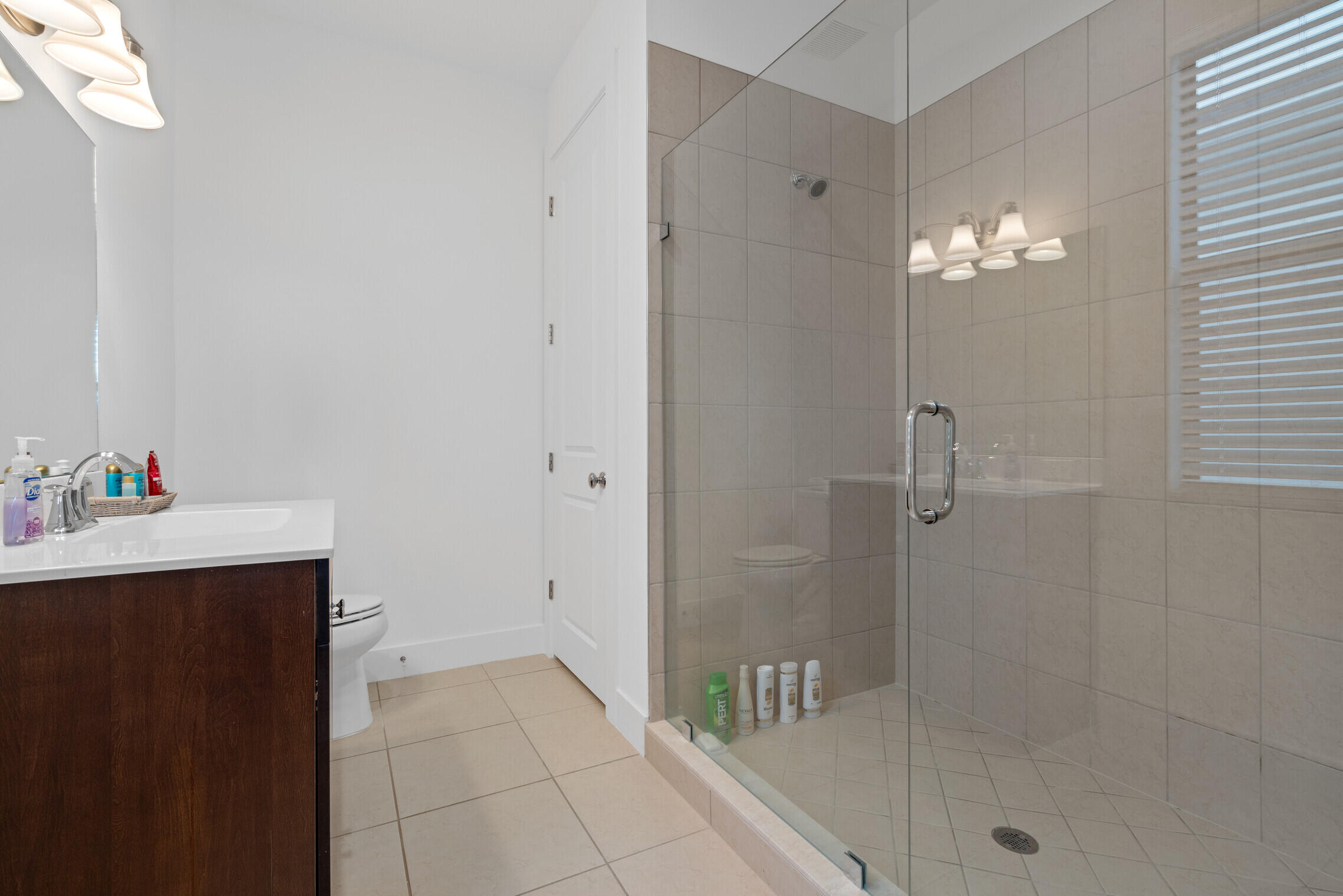 4084 Faraday Way Palm Beach Gardens, FL 33418 - Photo 38 of 43 a bathroom with a sink shower and a mirror