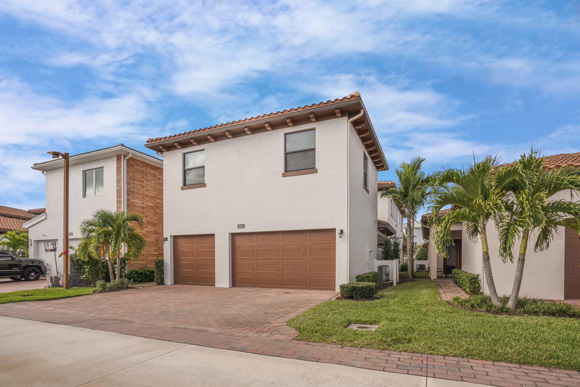 4084 Faraday Way Palm Beach Gardens, FL 33418 - Photo 39 of 43 a front view of a house with a yard and garage