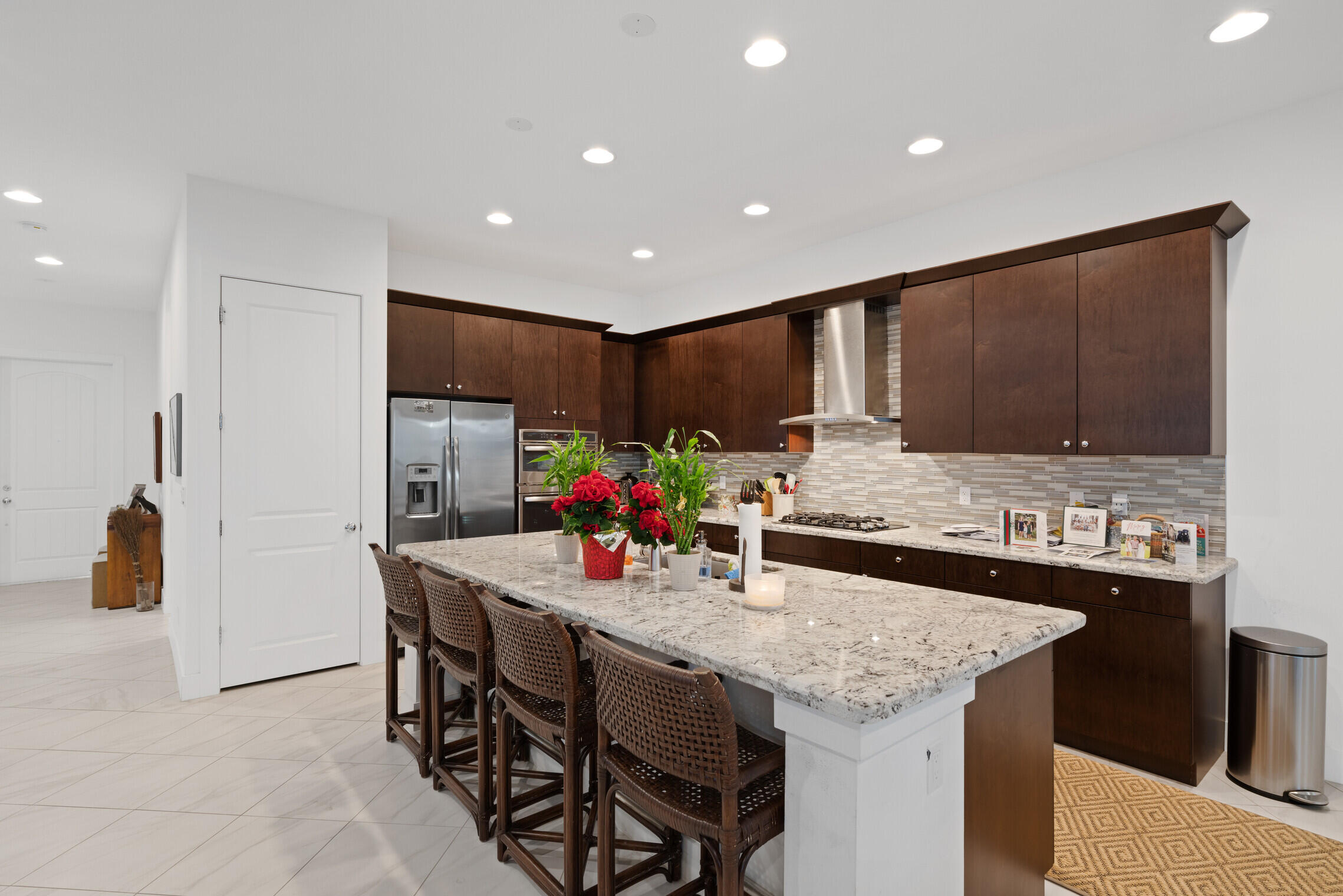 4084 Faraday Way Palm Beach Gardens, FL 33418 - Photo 10 of 43 a kitchen with granite countertop a table chairs stove and refrigerator
