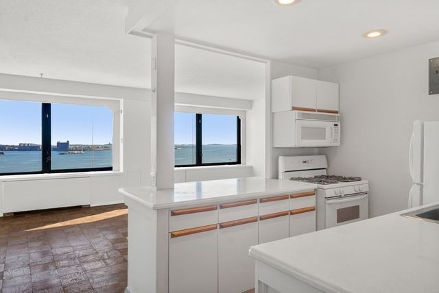 a kitchen with stainless steel appliances a stove a sink and a microwave