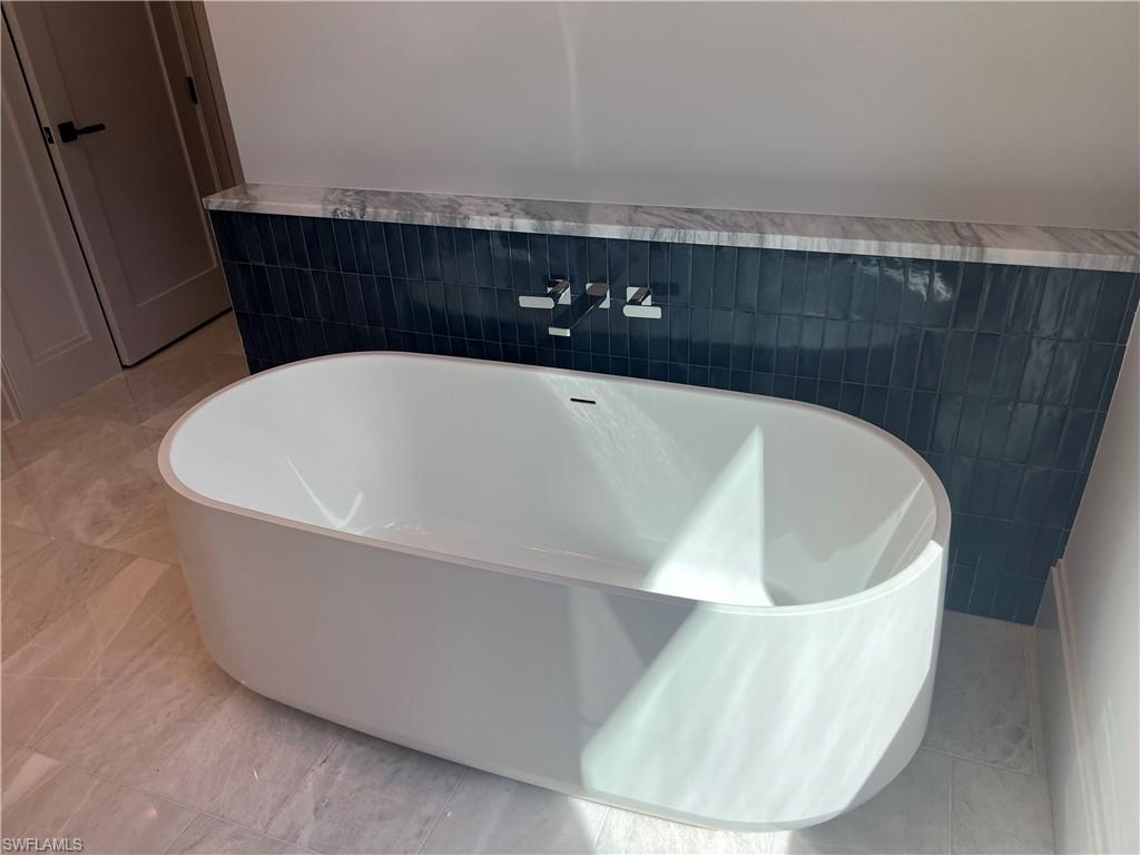 6708 Newport Road Naples, FL 34109 - Photo 14 of 48 Full bathroom featuring a freestanding bath