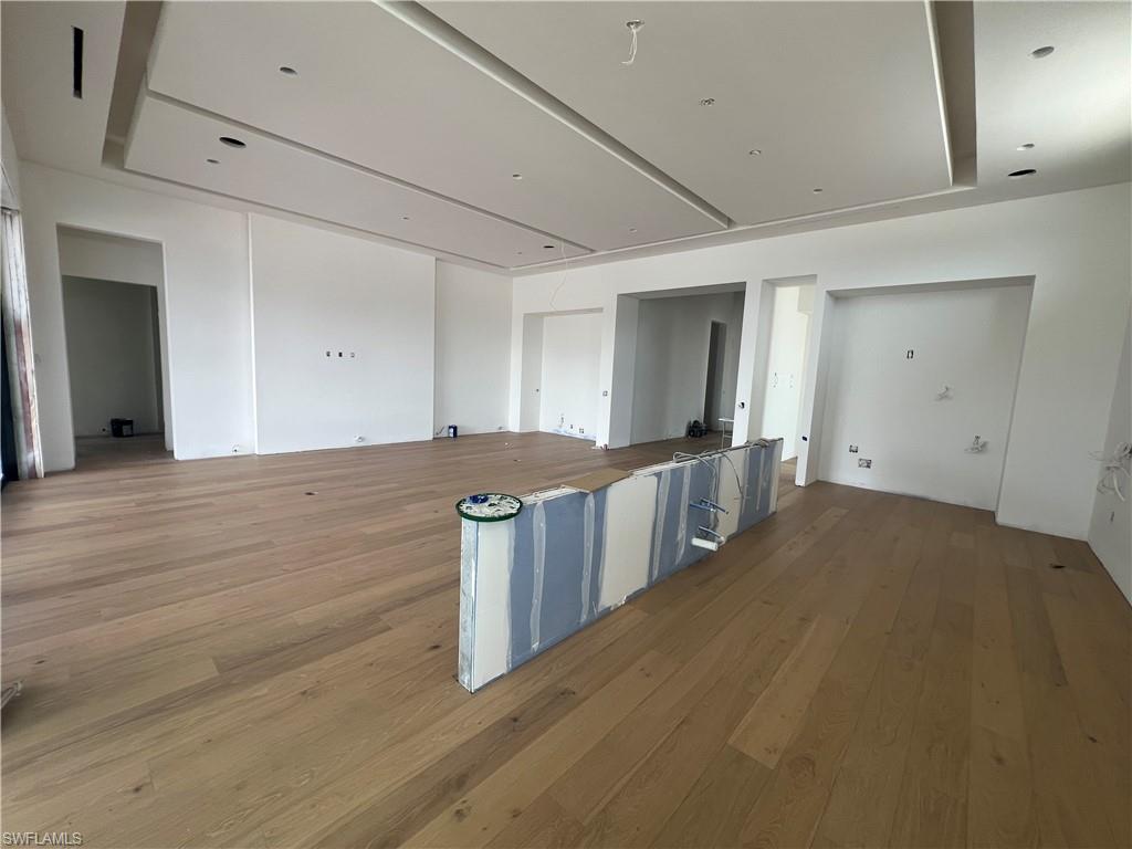 6708 Newport Road Naples, FL 34109 - Photo 2 of 50 a view of a hallway with wooden floor