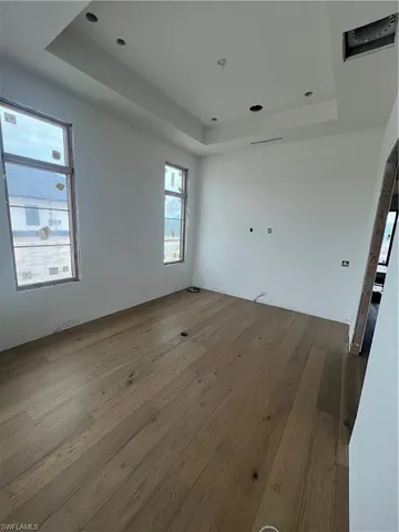 a view of wooden floor and windows in a room