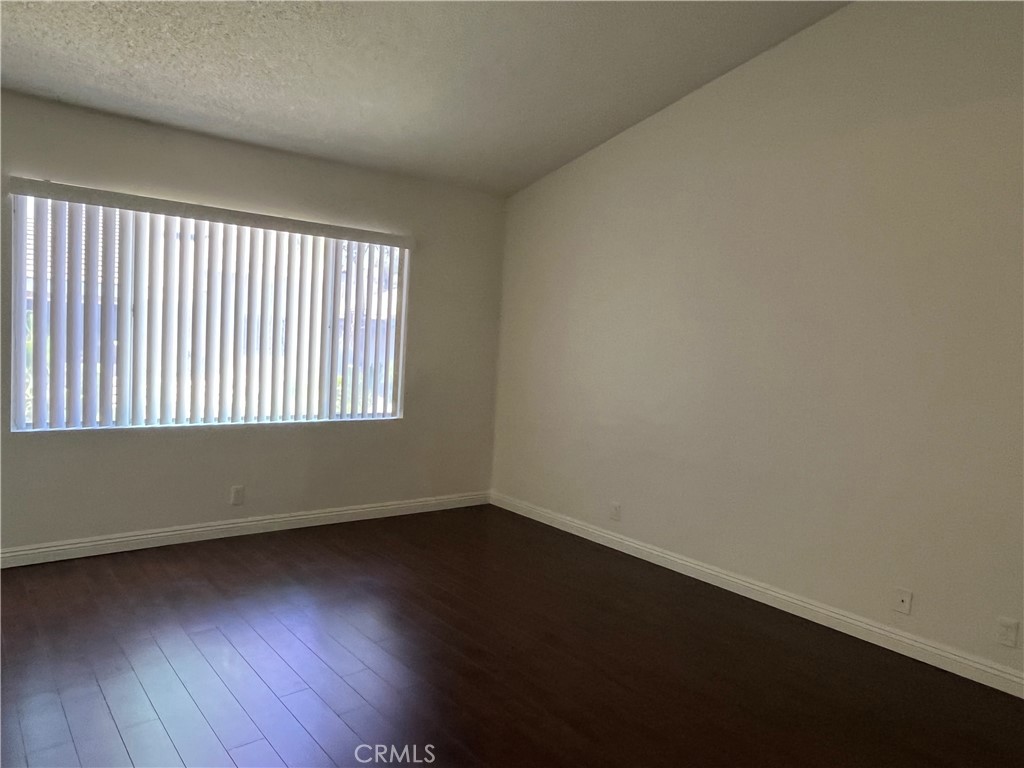 11568 Norgate Circle Corona, CA 92878 - Photo 15 of 21 an empty room with wooden floor and windows