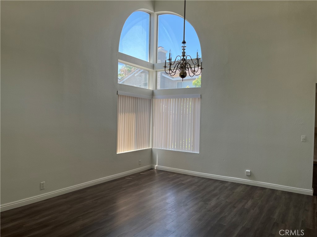 11568 Norgate Circle Corona, CA 92878 - Photo 3 of 21 an empty room with wooden floor and windows