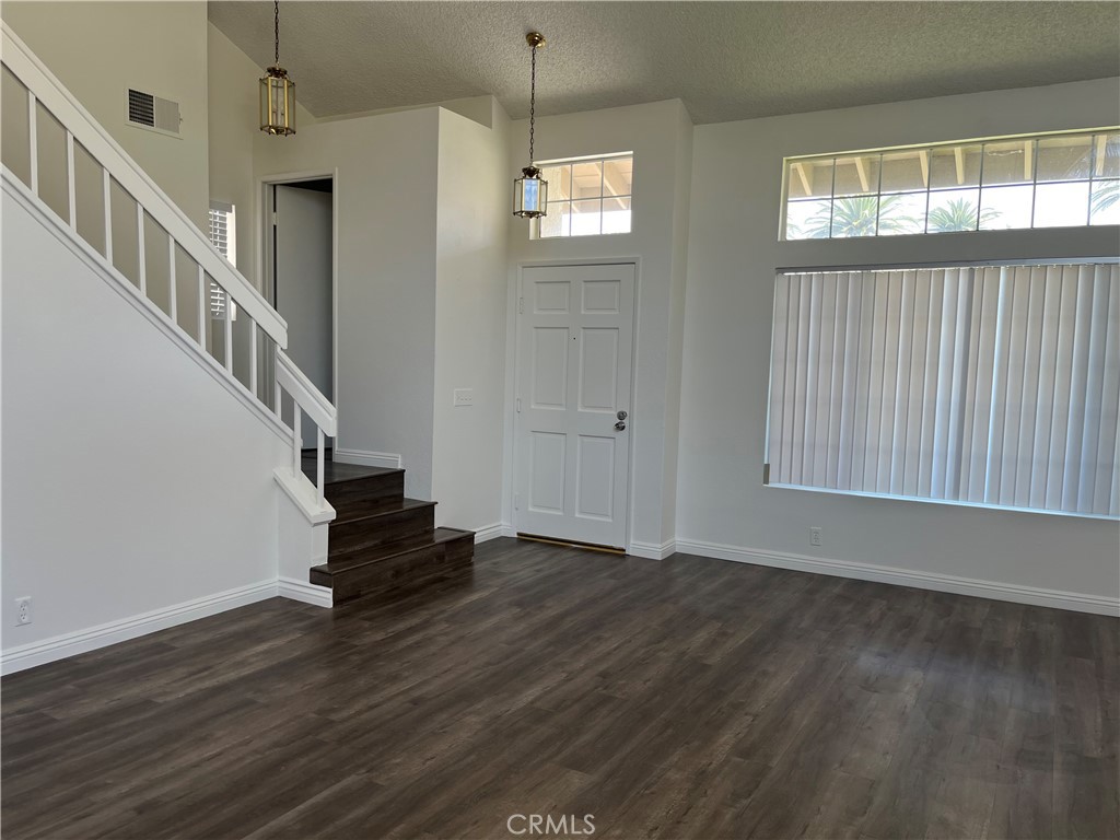 11568 Norgate Circle Corona, CA 92878 - Photo 4 of 21 a view of entryway and hall with wooden floor