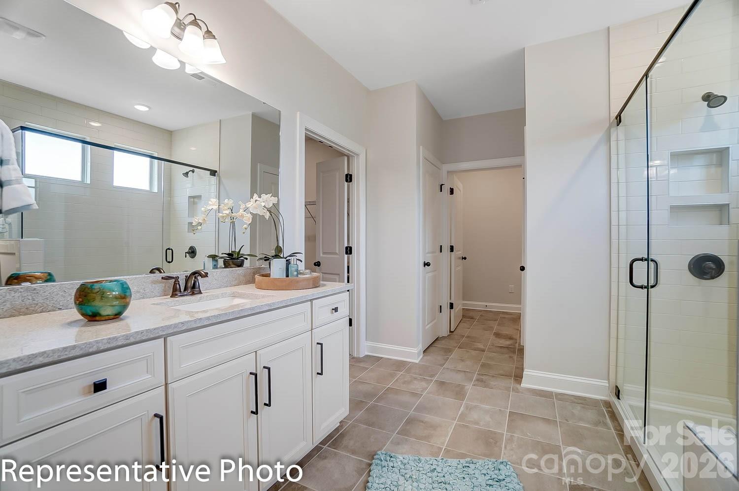 2038 Mantle Rdg Drive Indian Trail, NC 28079 - Photo 12 of 15 a bathroom with a double vanity sink mirror and shower