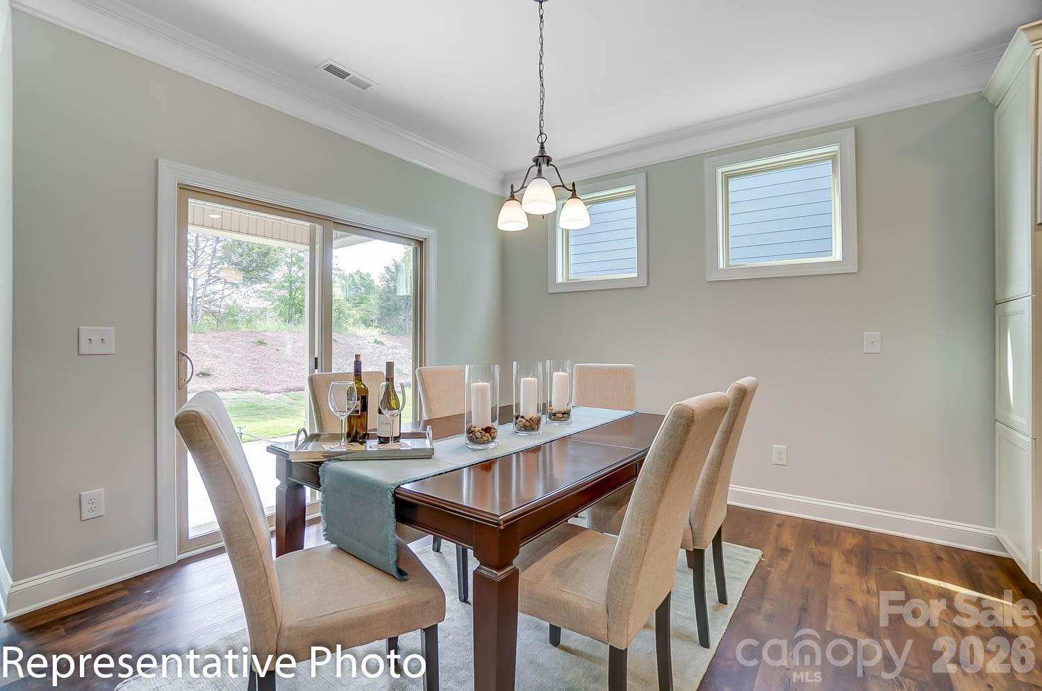 2038 Mantle Rdg Drive Indian Trail, NC 28079 - Photo 10 of 15 a view of a dining room with furniture wooden floor and a chandelier