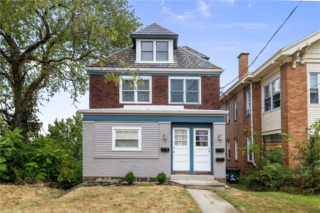 a front view of a house with a yard