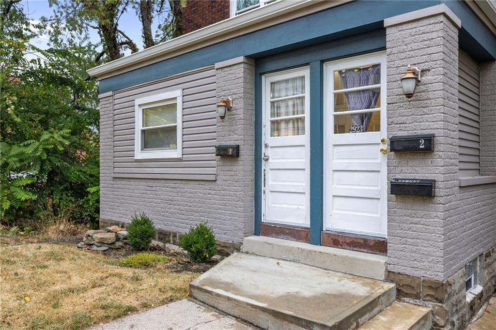 2923-2925 Brownsville Road Pittsburgh, PA 15227 - Photo 2 of 38 a front view of a house with a yard