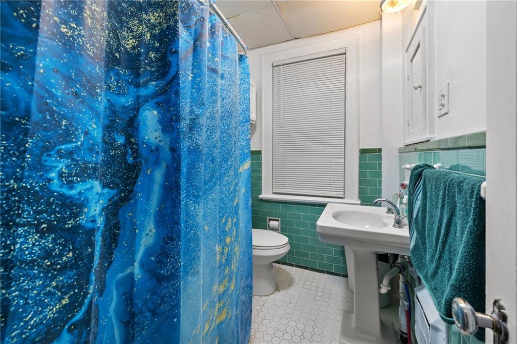 2923-2925 Brownsville Road Pittsburgh, PA 15227 - Photo 23 of 38 a view of a bathroom with a sink and a toilet