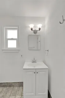 a bathroom with a sink vanity and a mirror