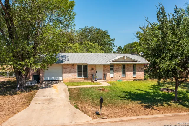 a front view of a house with a yard table and chairs