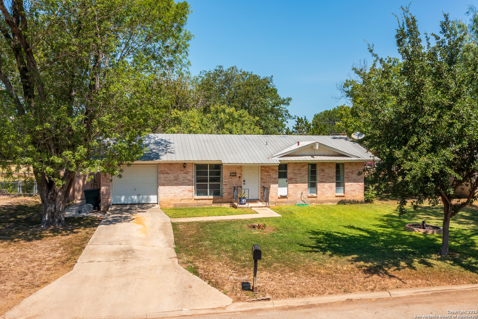 a front view of a house with a yard table and chairs
