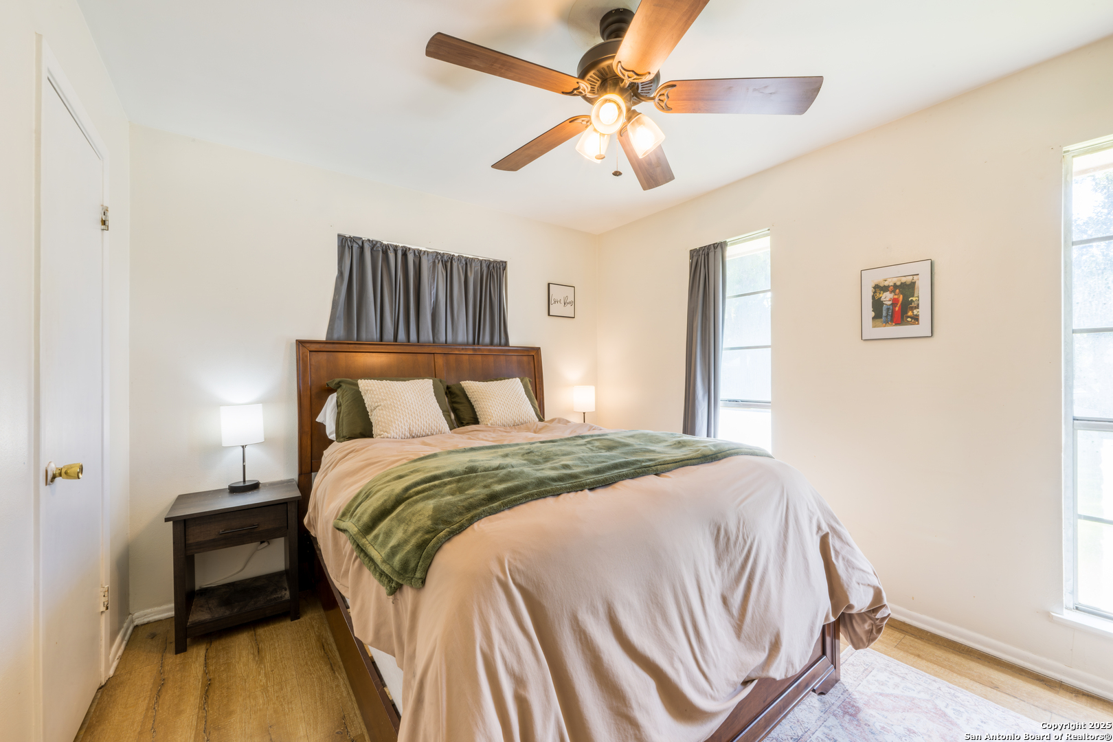 112 East Knippa Street Uvalde, TX 78801 - Photo 3 of 14 a bedroom with a bed and a chandelier