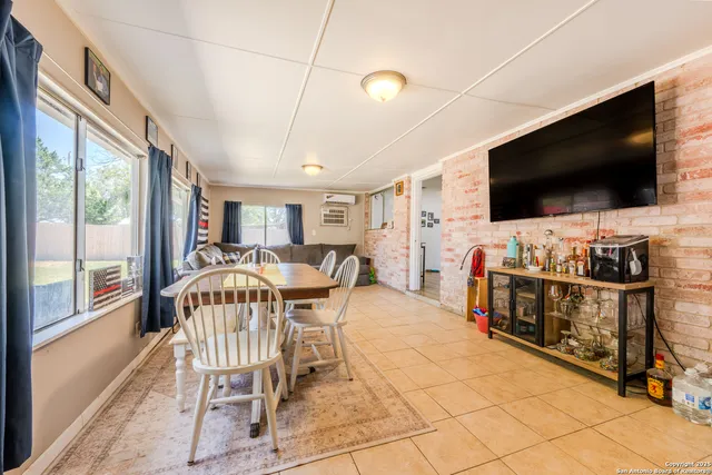 a view of a dining room with furniture large windows and wooden floor