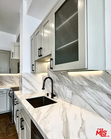 a kitchen with a sink and a refrigerator