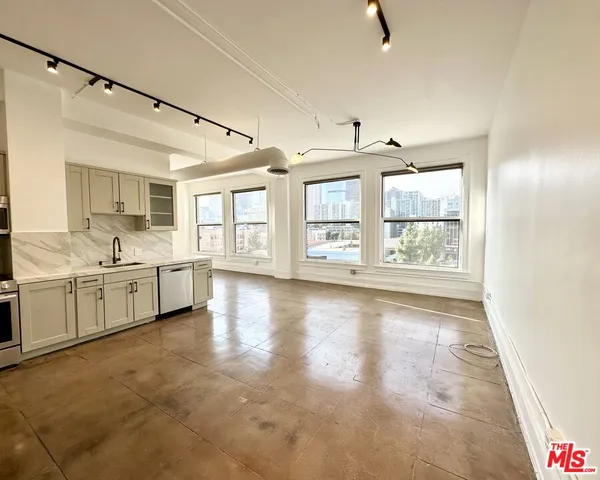 a view of a kitchen with a sink and window