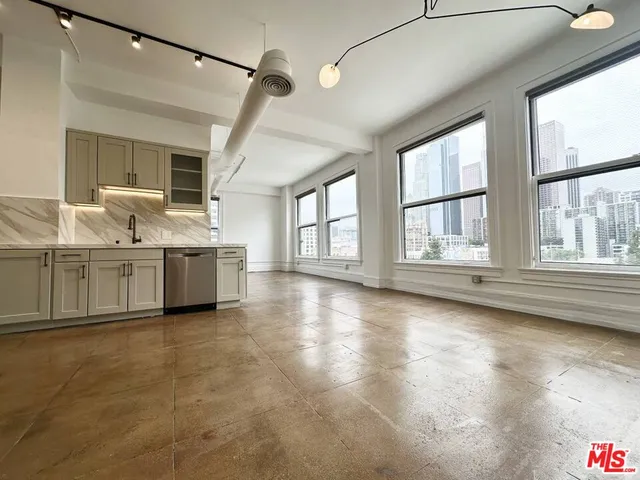 a view of a kitchen with stove and cabinets