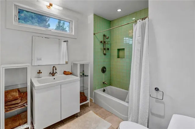 a bathroom with a sink mirror toilet and bathtub