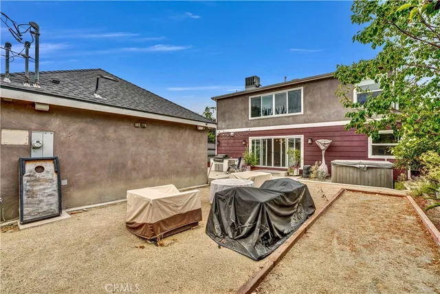 a view of a patio with table and chairs with wooden fence and plants