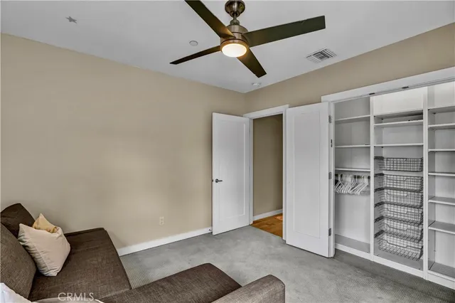 a view of empty room with wooden floor and closet